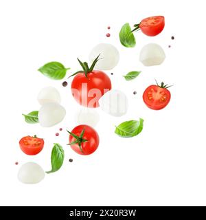 Flying mozzarella cheese balls, tomatoes, basil leaves and peppercorns for caprese salad isolated on white background. Mockup for advertising or produ Stock Photo