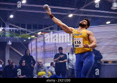 Ukrainian shot put athlete Ruslan Valitov throws a 7.26 kg iron ball at indoor Championship of Ukraine in track and field athletics. Kyiv - 2 February, 2024 Stock Photo