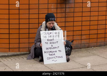 Leeds, UK. 19 APR, 2024. Demonstrators gather outside Leeds combined court as part of Defend Our Juries protest After gathering for a photograph the protestors sat either side of the court main entrance and did not block access. The protestors all held the same sign of  “Jurors have an absolute right to acquit a defendant according to their conscience” as has been seen with other protests taken at other crown courts across the country. Credit Milo Chandler/Alamy Live News Stock Photo