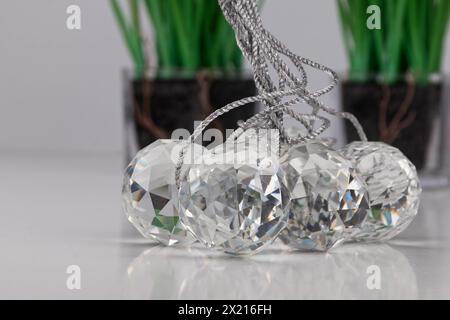 a group of cut glass balls lying on a white surface with real shadows, close up image Stock Photo