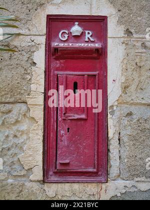 Bridgetown, Barbados - Jan 28 2024: At the Parliament Buildings in Bridgetown, Barbados, a wall-mounted, red Georgian post box, marked GR, George Rex, Stock Photo