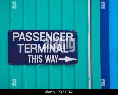 Bridgetown, Barbados - Jan 28 2024: A rectangular blue sign with white letters on a green background points the way to the passenger terminal at the P Stock Photo