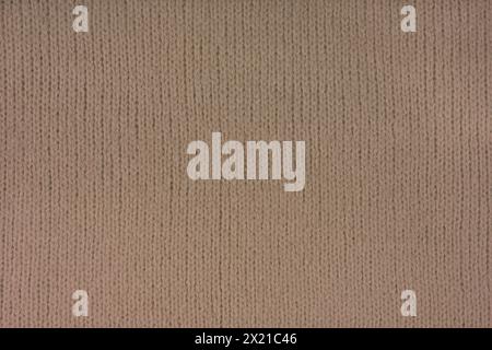 Brown knitted woolen jersey fabric, sweater, pullover texture background. Fabric abstract backdrop, cloth wallpaper Stock Photo