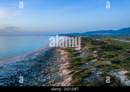 Wild beach with green bushes in Sardinia aerial drone view at sunset Stock Photo