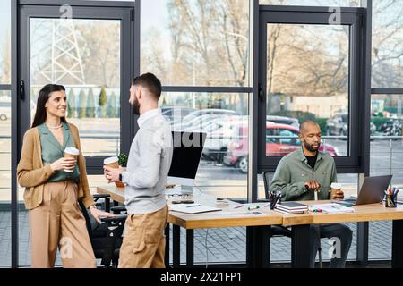 A diverse group of professionals brainstorm ideas and work on a project together around a wooden table in an office setting. Stock Photo