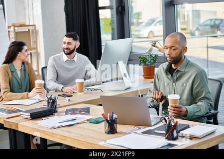 A diverse group of professionals brainstorming and collaborating on projects using laptops in a stylish office setting. Stock Photo