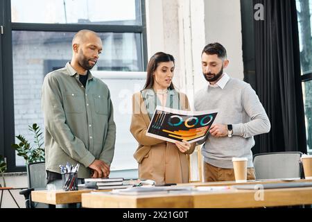 A diverse group of professionals stand around a table, engrossed in a magazine, brainstorming ideas for a project in an office setting. Stock Photo