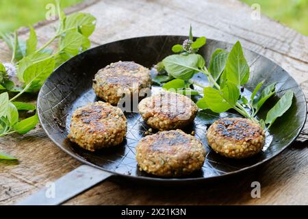 Making vegan herb patties, step 5: Ready-made herb patties arranged on a plate, serial image 5/5 Stock Photo