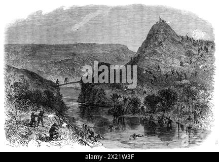 Fight at Waiari, on the Mangapiko River, New Zealand, on the 11th of February, 1864. 'It seems that...some of our soldiers went into the river to bathe, and were suddenly fired upon by the Maoris, who lay in ambush on the opposite bank. The covering party...immediately replied to the enemy's fire, while the bathers got out and dressed themselves as quickly as they could. The Maoris now slowly retired towards the old fortifications on the neck of the peninsula...Captain Fisher discovered a bridge over the river...[and crossing it,] came full upon the retiring ambuscade party of the enemy...[who Stock Photo