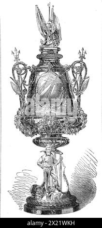 The Town Cup of the Royal Victoria Yacht Club, 1865. '...the cup...is a vase of embossed silver, on a pedestal, with the figure of a yachtsman leaning on a rudder, a yacht in full sail displayed on the shield above; the handles formed of tridents, and the lid surmounted by a pair of banners, with other subordinate features. Its weight is 40 oz., and it was furnished by Mr. Barnard, silversmith, of Ryde'. From &quot;Illustrated London News&quot;, 1865. Stock Photo