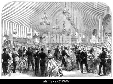 The International Naval Festival at Portsmouth: ball at the Royal Naval College, 1865. 'The spacious tent in which...[the ball] was held - occupying...the whole quadrangle in the rear of the college - had...been still further decorated. The lighting of the interior was executed by Messrs. Thomas Tucker and Sons...On each side of the ball-room, which was made dazzlingly bright by the light of twenty-five crystal lustres from the roof, besides eighty wall candelabra, and twelve placed in vases of flowers on the floor, were alcoves with seats, in which the ladies, when fatigued with the dance, re Stock Photo
