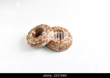 Two round gingerbread cookies covered with glaze on a white background. Stock Photo