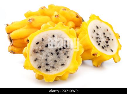 Yellow pitahaya or yellow dragon fruit and cross cuts of fruit with white flesh and black seeds on white background. Stock Photo