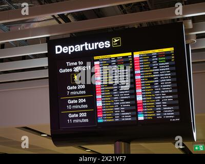 Manchester, UK - Jan 21 2024: An electronic flight departure information display at Manchester Airport in England, UK. Flight times and the times to w Stock Photo