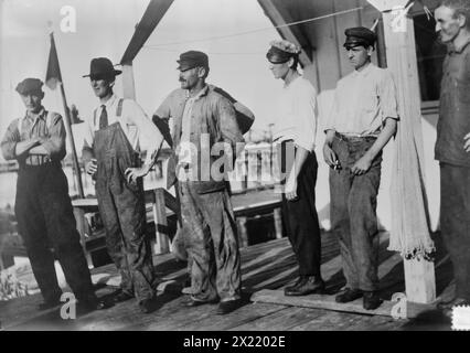 Escaped from Tampico, in launch, 1914. Shows seven men who escaped in a small boat from Tampico, Mexico arriving in Galveston, Texas. The men left during the U.S. occupation of Veracruz, Mexico at the time of the Mexican Revolution. Stock Photo