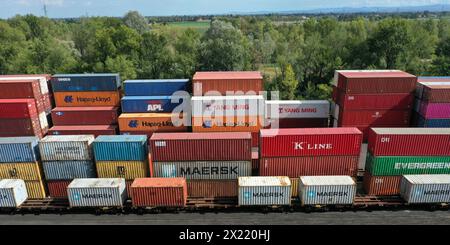 A bunch of intermodal containers of various colors ready to be loaded on board a cargo container ship. Concept of Standard Cargo Worthy Shipping Conta Stock Photo