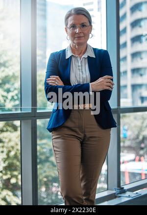 Arms crossed, portrait or mature businesswoman in office for professional mindset, ambition or empowerment. Ready, corporate worker and face of Stock Photo