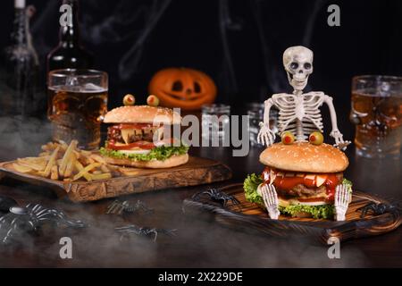 A Monster Burger on a sitting skeleton in the fog will definitely lift the spirits and is the perfect Halloween party appetizer. Stock Photo
