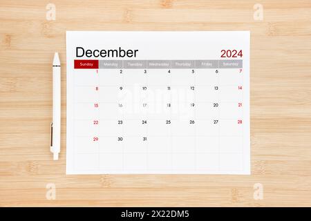 December 2024 calendar page on wooden background. Stock Photo