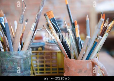 Different brushes in drawing studio interior. Close up view Stock Photo