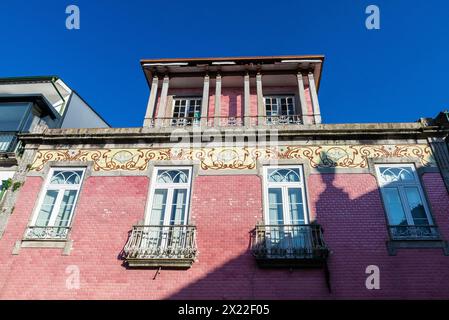 Facade of an old classic red building decorated with tiles in the old town of Braga, Portugal Stock Photo