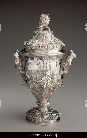 Two-Handled Cup, c1726. This two-handled silver cup is decorated with an enormous variety of abstract and natural forms. These include representations of the infant Bacchus, the Roman god of wine, as well as lions, scrolls, shells, and a miniature lizard resting on top of the lid. Stock Photo