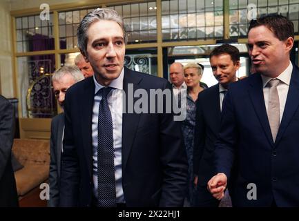 Taoiseach Simon Harris (left) with Minister of State at the Department of Agriculture Martin Heydon (right), as he arrives to attend the European People's Party conference on the future of European agriculture at the Woodford Dolmen Hotel, Co. Carlow. The Taoiseach has said he is “eager to be in a position to apologise” to the families of those killed in the Stardust fire tragedy. Families of the 48 young people who died in the blaze that ripped through the nightclub in north Dublin in 1981 have called for an official state apology. Picture date: Friday April 19, 2024. Stock Photo