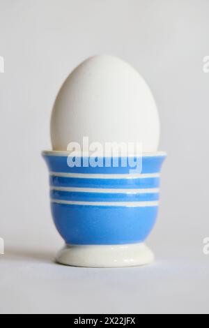 White egg in a blue and white ceramic egg cup Stock Photo