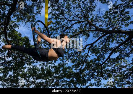 Young Latin American woman in the open-air aerial hoop Stock Photo