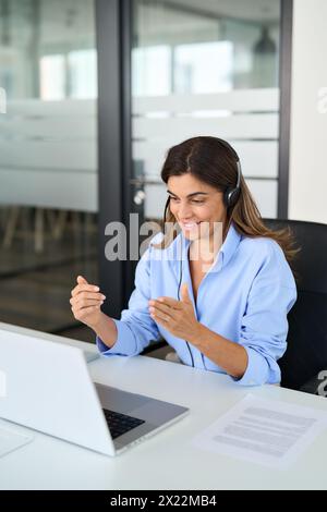 Busy Hispanic woman call center support agent working using laptop in office. Stock Photo