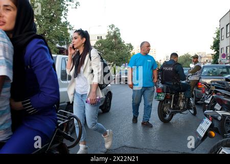 An Iranian Girl in Tehran resisting compulsory hijab by walking without scarfs in public. Stock Photo