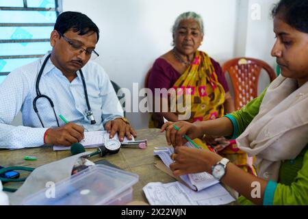 Indian female doctor prescribing medicine to young adult girl patient ...