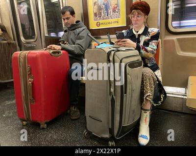 Subway riders with their luggage in New York on Sunday, April 14, 2024. (© Frances M. Roberts) Stock Photo