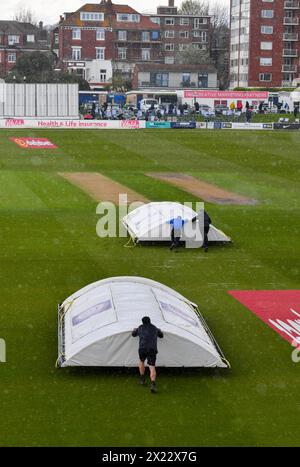 Hove UK 19th April 2024 -  The covers come on as rain stops play during the Vitality County Championship League Two cricket match at the 1st Central County Ground in Hove : Credit Simon Dack /TPI/ Alamy Live News Stock Photo