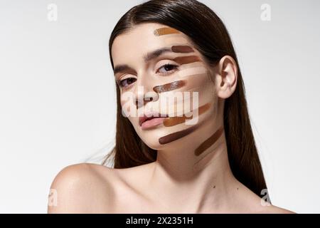 Graceful young woman showcasing beauty products like foundation. Stock Photo