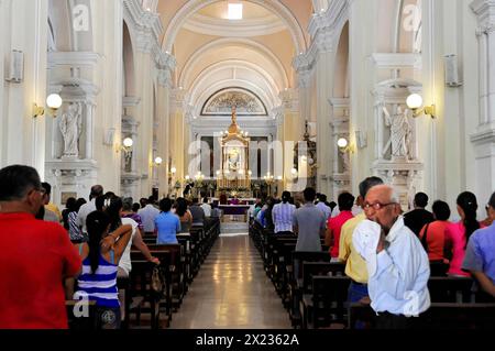 Catedral de la Asuncion, built in 1860, Leon, Nicaragua, People during a service inside a church looking towards the altar, Central America, Central Stock Photo