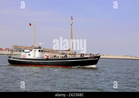 Sylt, North Frisian Island, Schleswig Holstein, A small ship with German flags sails on the sea, Sylt, North Frisian Island, Schleswig Holstein Stock Photo