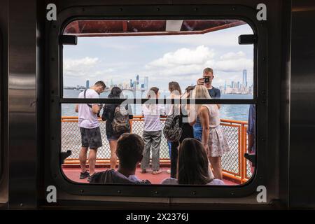 Tourists on the Staten Island ferry with a view of the Manhattan skyline, New York City, USA, New York City, New York, USA Stock Photo
