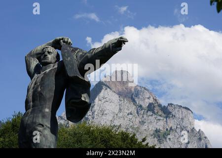 Monument to military readiness in the town Schwyz. Cutout showing a staute of a man putting on a jacket. Stock Photo