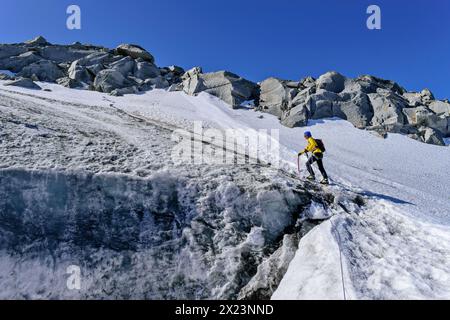 Mountaineering woman ascends over glacier, Schwarzensteinkees, Schwarzenstein, Zillertal Alps, Zillertal Alps Nature Park, Tyrol, Austria Stock Photo