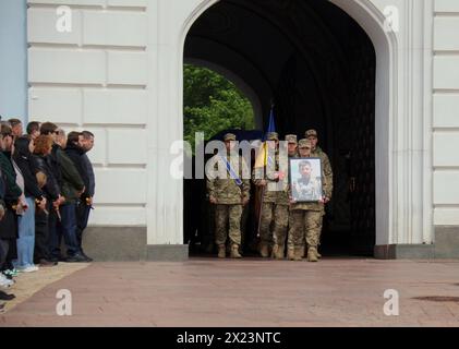 KYIV, UKRAINE - APRIL 19, 2024 - The funeral procession emerges from St Michael’s Golden-Domed Monastery following the memorial service for Sergeant of the 59th Brigade Pavlo Petrychenko who perished while defending Ukraine from Russian troops, Kyiv, capital of Ukraine. Ukrainian serviceman and activist Pavlo Petrychenko was a sergeant in the 59th Separate Motorized Infantry Brigade and the author of the petition that urged to limit online casinos for military personnel during martial law, which garnered the 25,000 votes needed to be considered by the President within hours of its publication. Stock Photo