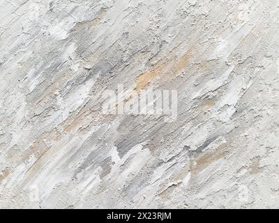 Abstract structure background with a texture paste material. Gray and white contrast with orange paint. Stucco filler on an art canvas. Stock Photo