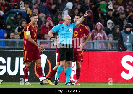 Rome, Italy. 18th Apr, 2024. Referee Szymon Marciniak shows a red card to Zeki Celik of AS Roma during the UEFA Europa League 2023/24 Quarter-Final second leg match between AS Roma and AC Milan at Stadio Olimpico on April 18, 2024 in Rome, Italy. Credit: Giuseppe Maffia/Alamy Live News Stock Photo
