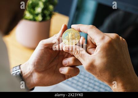 man holding bitcoin in hand. crypto buying and investment concept. blockchain and digital assets Stock Photo