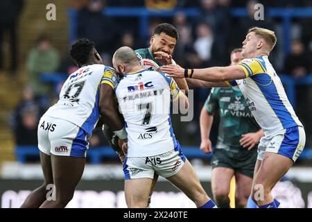 Esan Marsters of Huddersfield Giants is tackled by Justin Sangare of Leeds Rhinos and Matt Frawley of Leeds Rhinos during the Betfred Super League Round 8 match Leeds Rhinos vs Huddersfield Giants at Headingley Stadium, Leeds, United Kingdom, 19th April 2024  (Photo by Mark Cosgrove/News Images) Stock Photo