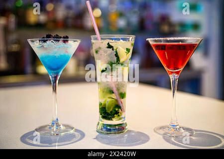 Three cocktails: Blue Lagoon, Mojito and Cranberry Martini Stock Photo