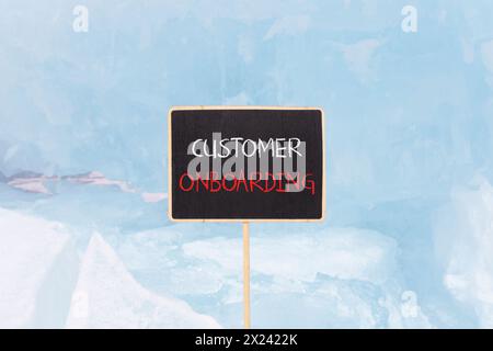 Customer onboarding symbol. Concept words Customer onboarding on beautiful yellow black blackboard. Beautiful blue ice background. Business Customer o Stock Photo