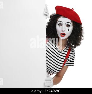 Funny mime with blank poster posing on white background Stock Photo