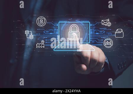 Man points at key icon on virtual screen of laptop Protecting security in online transactions identity theft internet cyber crime. Concept of protect Stock Photo