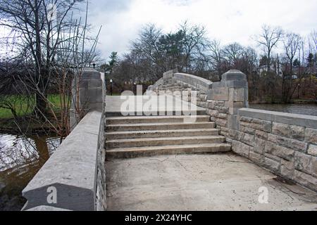 Cute stone bridge over Verona Lake in Verona Park, Verona, New Jersey, on an overcast day in early springtime-03 Stock Photo